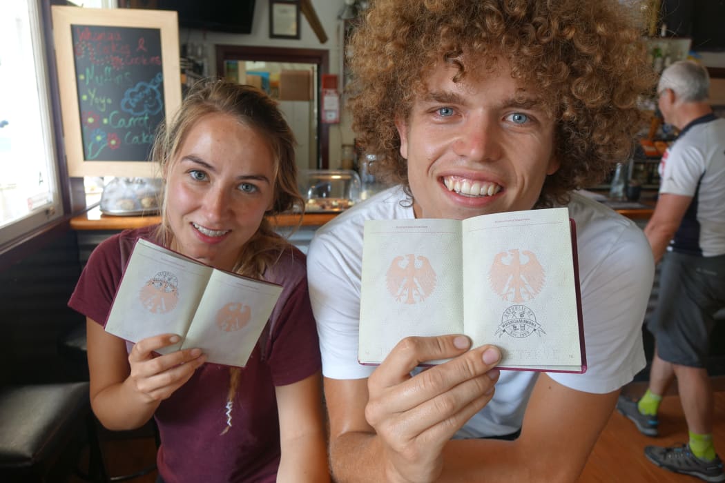 Tourists with their passports stamped.