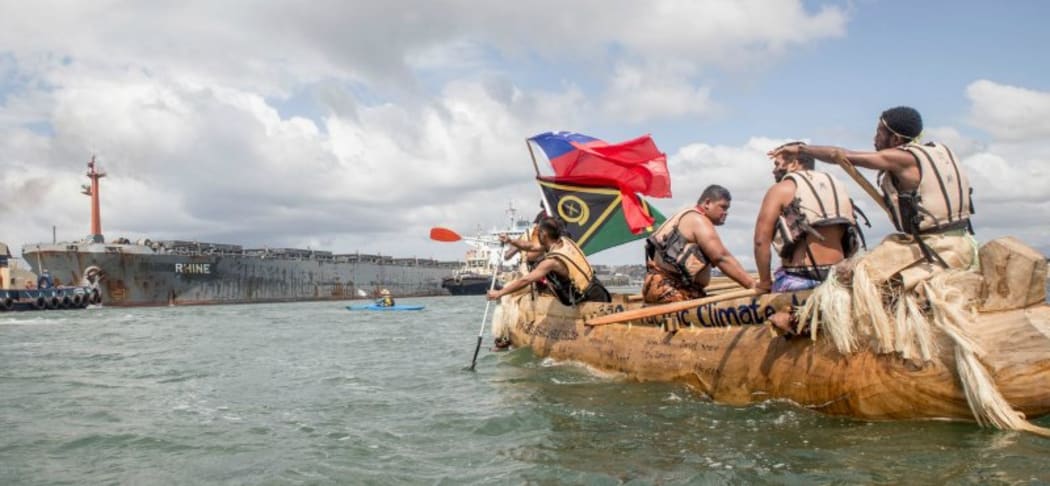 A Pacific Island canoe and a ship - Climate change demonstration