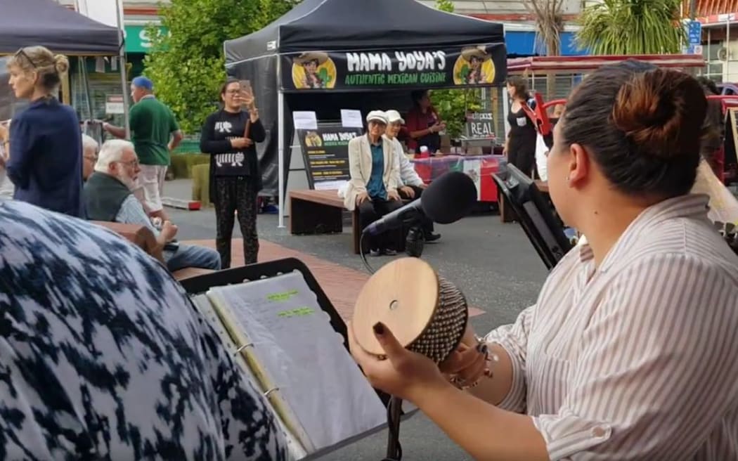 Screengrab of musicians performing at the New Lynn Night Market.