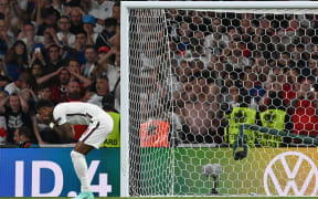 England's forward Marcus Rashford reacts after failing to score in the penalty shootout  during the UEFA EURO 2020 final football match between Italy and England at the Wembley Stadium in London.