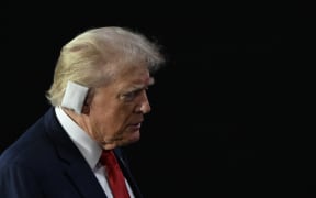 Former US President and 2024 Republican presidential candidate Donald Trump walks to his seat as he arrives during the first day of the 2024 Republican National Convention at the Fiserv Forum in Milwaukee, Wisconsin, July 15, 2024.