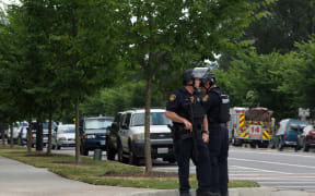Virginia Beach Police Officers near the intersection of Princess Anne Road and Nimmo Parkway following a shooting at the Virginia Beach Municipal Center on Friday, May 31, 2019