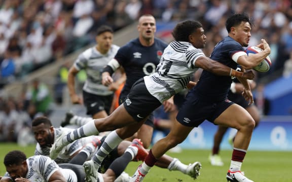 Fiji's Lekima Tagitagivalu tackles England's Marcus Smith during the World Cup warm-up match between England and Fiji at Twickenham Stadium on 26 August.