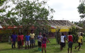 Kids are back at school and playing happily, while their school building is waiting for a new roof.