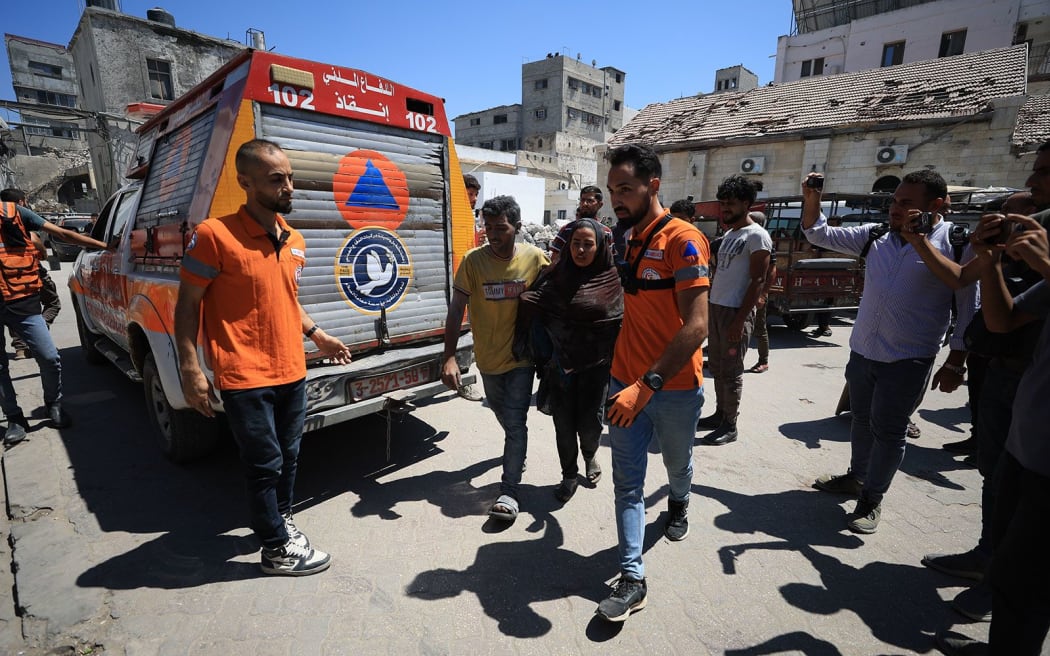 Injured Palestinians are brought to al-Ahli Baptist Hospital to receive medical treatment after an Israeli airstrike in the Gaza Strip on 4 July.