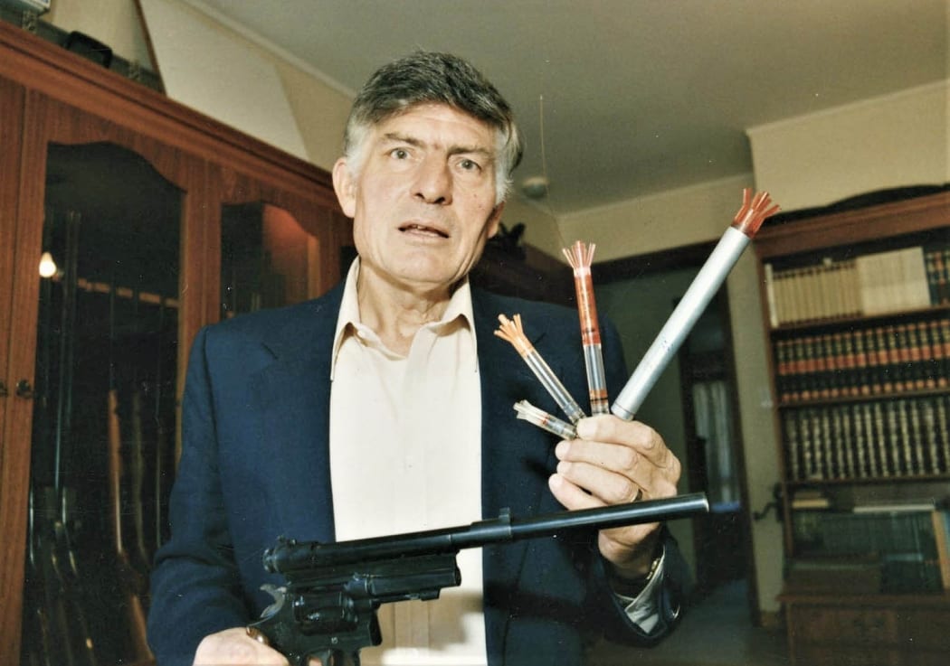 Colin Murdoch holds a tranquiliser gun and darts of his own invention.