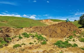 A digger works to clear a slip in Northland.