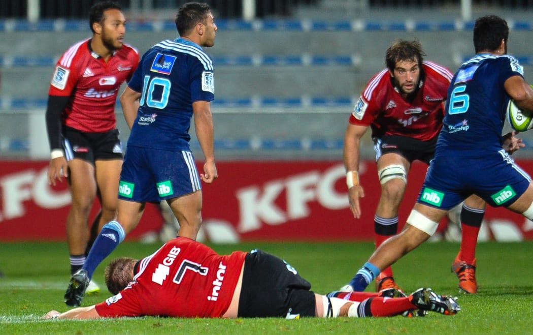 All Blacks captain Richie McCaw lies unconscious after a heavy tackle, while playing for the Crusaders against the Blues.