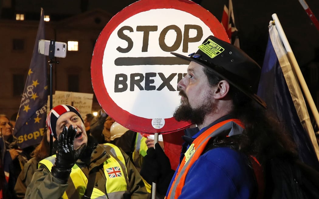 A pro-Brexit supporter, left, gestures at a remain supporter near the Parliament in London.