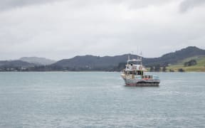 A fishing boat sits in the Hokianga Harbour
