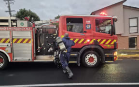 Firefighters at the scene of a fire in a townhouse in the Auckland suburb of Albany Heights on 16 March 2026.