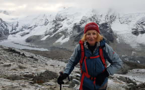 Hazel Nash standing in front of a snowy mountain peak.