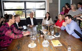 New Zealand Prime Minister Jacinda Ardern (centre R) speaks with senior members of parliament a day after her landslide election win.