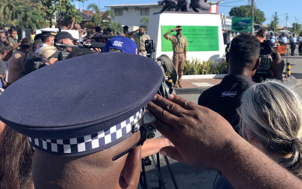 A Solomon Islands police officer salutes the Coastwatchers Monument at Point Cruz in Honiara during the 80th anniversary of the WWII Battle of Guadalcanal.