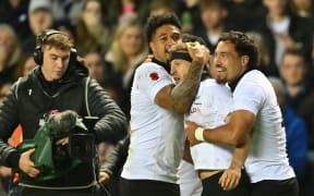New Zealand's Damian McKenzie celebrates scoring a try against Scotland.