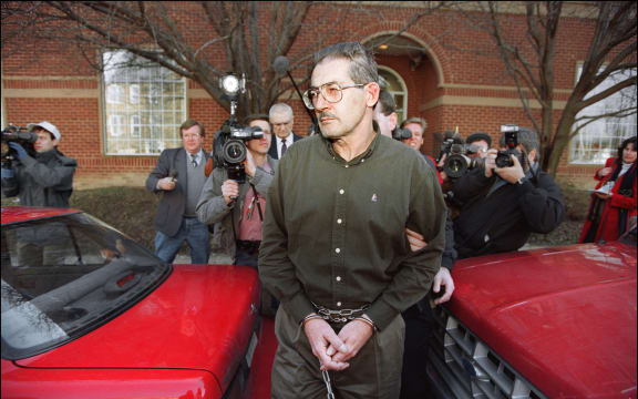 (FILES) Former senior Central Intelligence Agency office Aldrich Hazen Ames is led from US Federal Courthouse in Alexandria, 22 February 1994, after being arraigned on charges of spying for the former Soviet Union. Aldrich Ames, the Central Intelligence Agency spy who was sentenced to life in prison for selling secrets to Moscow, costing the lives of a dozen double agents, died January 5 in custody, US authorities said.
He was 84, according to the Bureau of Prisons. (Photo by LUKE FRAZZA / AFP)