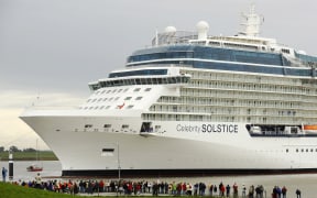 Onlookers watch luxury cruise liner "Celebrity Solstice" being towed past a lock on the Ems river in Gandersum, northern Germany, on September 29, 2008. The ship, Germany's biggest of its kind, built at the Meyer Werft shipyards in Papenburg, is due to reach the North Sea over the Ems river.
