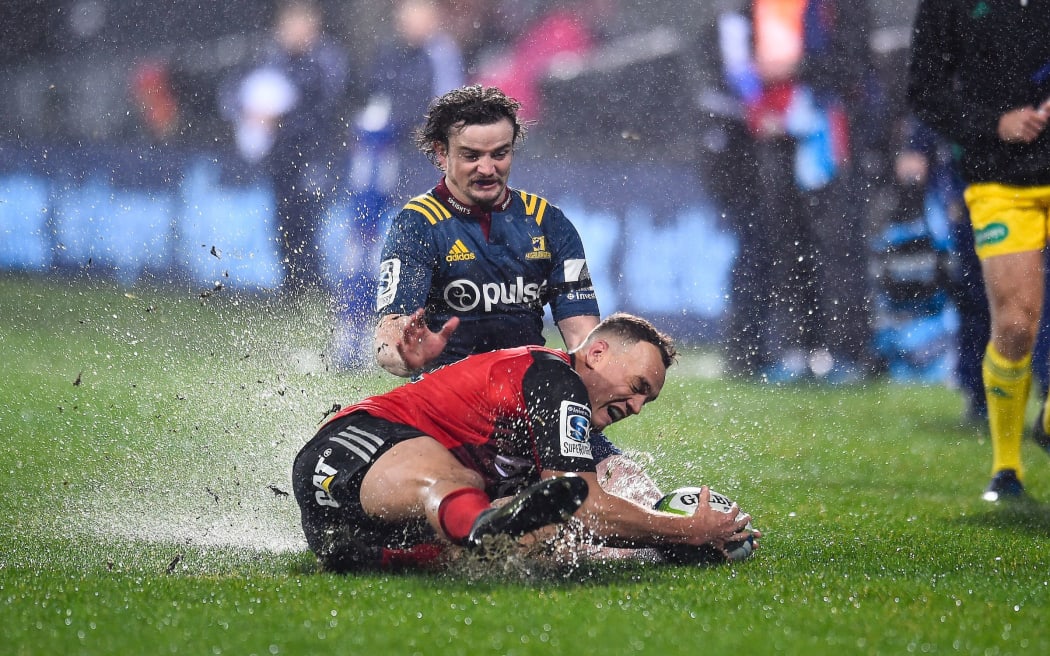 Israel Dagg of the Crusaders is tackled by Richard Buckman of the Highlanders.