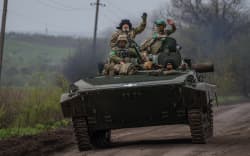 Ukrainian servicemen ride in a BMP infantry fighting vehicle near the town of Bakhmut, in the Donetsk region, on April 28, 2023, amid the Russian invasion on Ukraine. (Photo by Dimitar DILKOFF / AFP)
