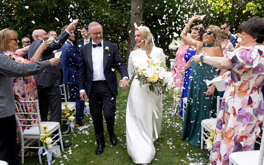 Australia’s Prime Minister Anthony Albanese (L) and his new wife Jodie Haydon walk together during their wedding ceremony in Canberra on November 29, 2025. (Photo by MIKE BOWERS / AFP) / -- IMAGE RESTRICTED TO EDITORIAL USE - STRICTLY NO COMMERCIAL USE --