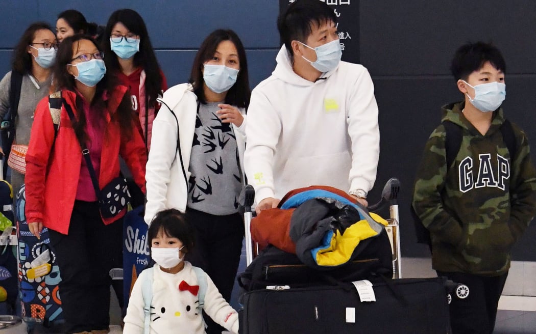 Passengers from China, wearing masks, arrive at Chubu Centrair International Airport in Tokoname City, Aichi Prefecture, middle of Japan, on January 27, 2020.