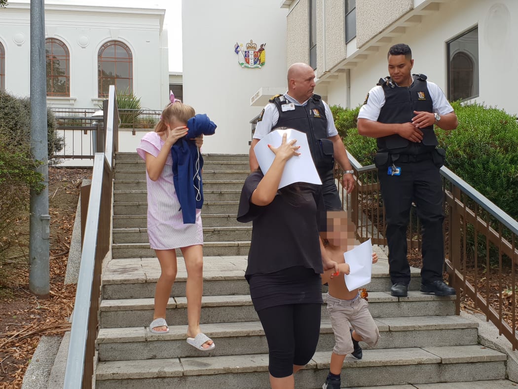 Tina Maria Cash (center) leaves the Hamilton district Court.