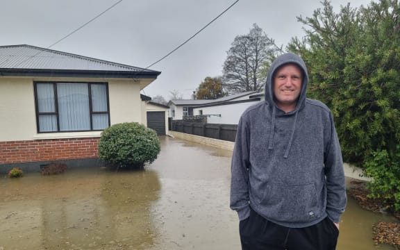 Gore resident Justin White arrived home to find his front yard flooded, some parts are 30 centimetres or more deep. He says there is sewage floating in it.