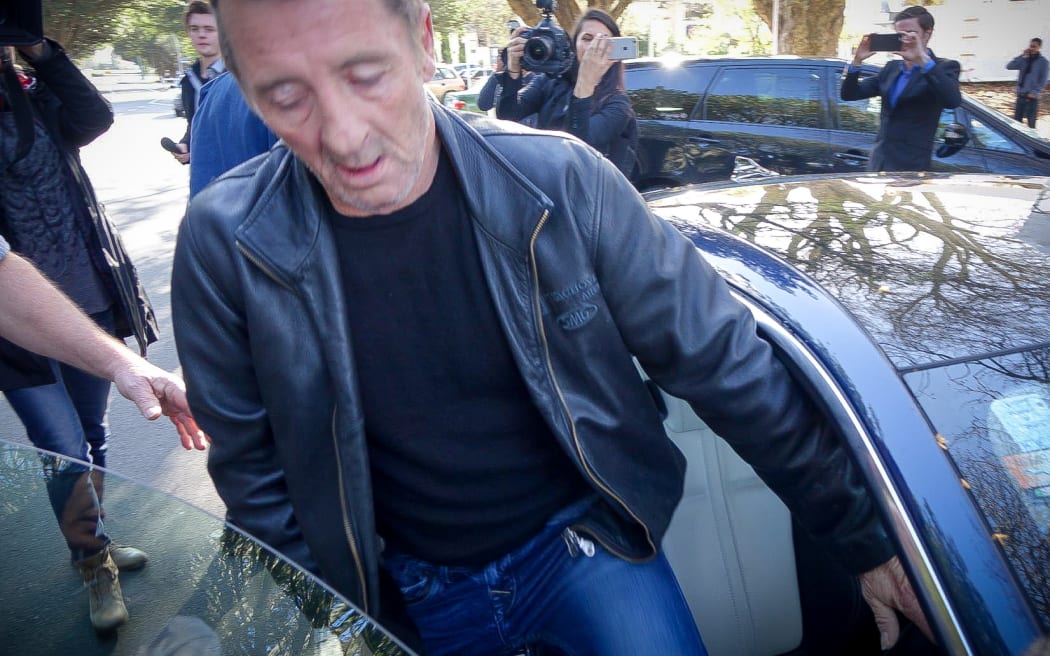 Phil Rudd gets into a Jaguar and drives away from Tauranga District Court.