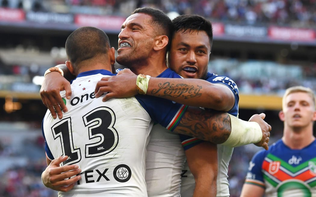 Marcelo Montoya (C) of the Warriors celebrates a try against the Redcliffe Dolphins.