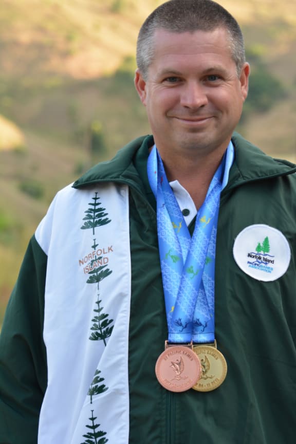 Douglas Creek from Norfolk Island shot his way to a gold winning performance in the mixed 25m air pistol competition.