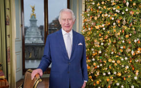 Britain's King Charles III poses during the recording of his Christmas message at Buckingham Palace, London, on 7 December 2023. (Photo by Jonathan Brady / POOL / AFP)