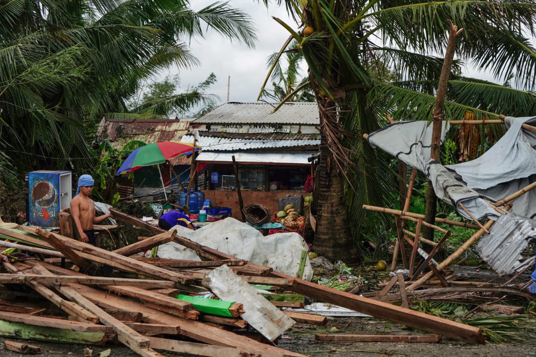 A resident looks at a house damaged at the height of Typhoon Phanfone in Tacloban, Leyte province in the central Philippines on December 25, 2019.