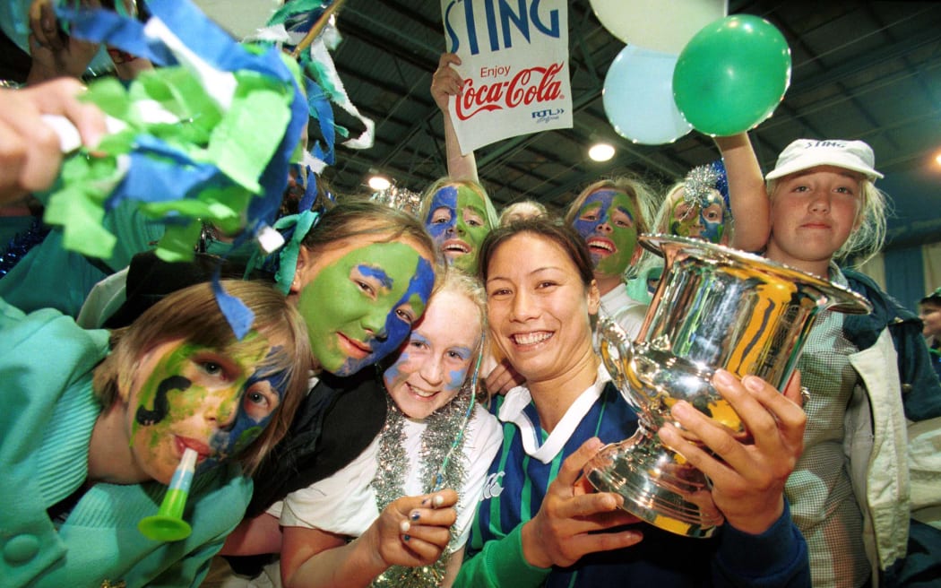 Bernice Mene of the Southern Stings with fans and the winners trophy. 
Sting v Rebels, Coca-Cola Cup final, National Netball Championships, 1999. Copyright Photo: www.photosport.nz