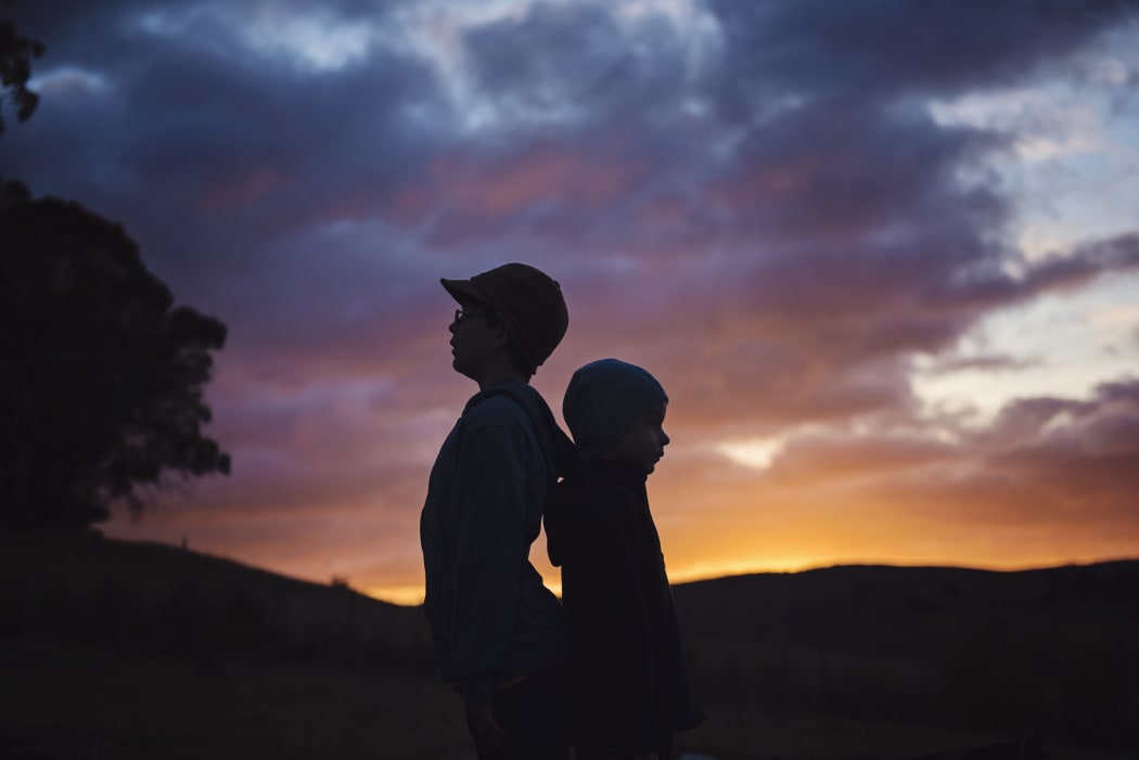 brothers at sunset