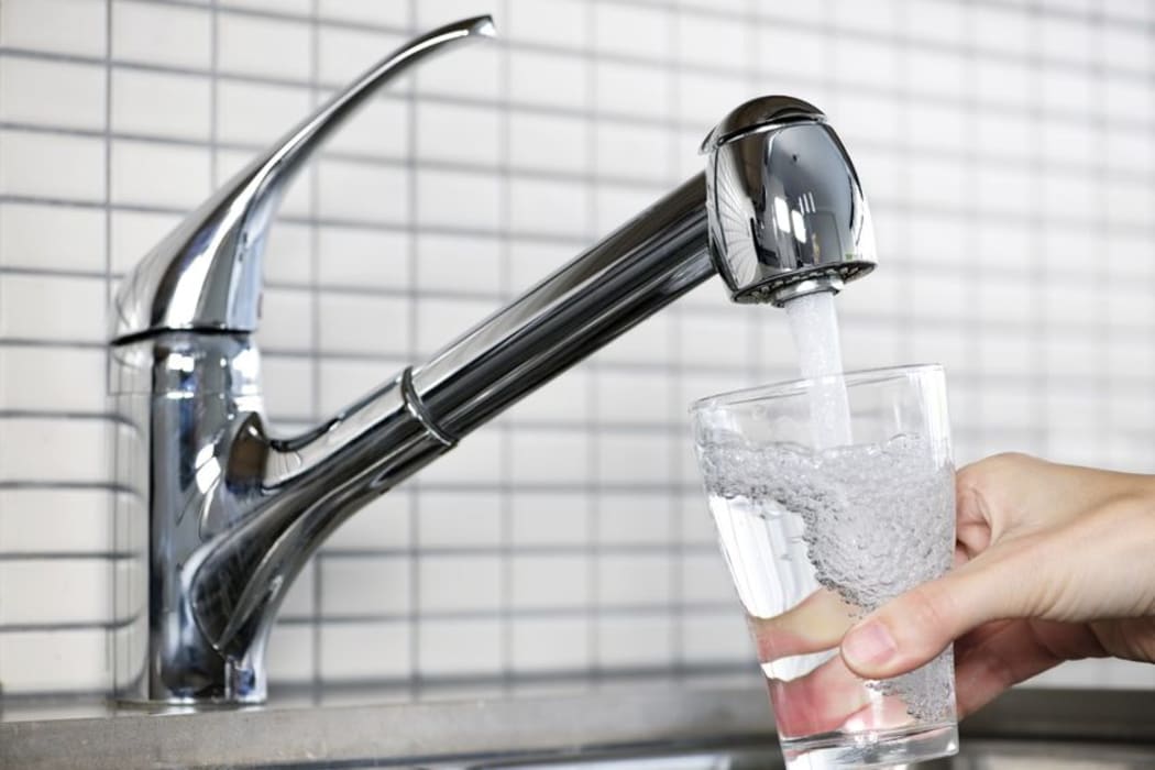 water running from a tap into a glass