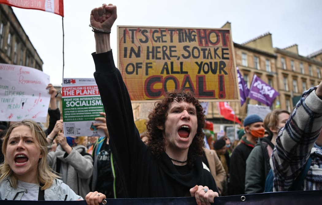 Youth activists shout as they march to protest against climate inaction on the sidelines of the COP26 UN Climate Summit in Glasgow on November 5, 2021.