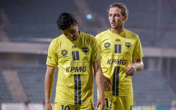 Ulises Davila and Matthew Ridenton of the Phoenix react to loss.