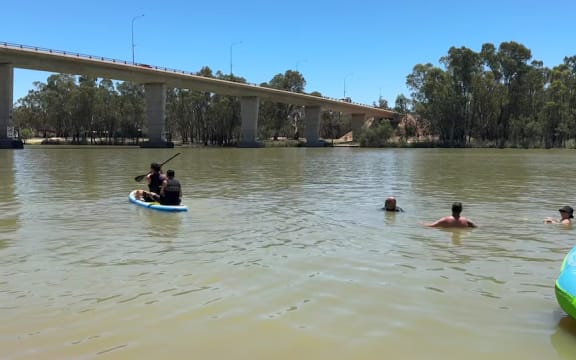 Swimmers cool off at the George Chaffey Bridge Boat Ramp in Mildura in northern Victoria on Tuesday. (ABC News: Wade Stephens)