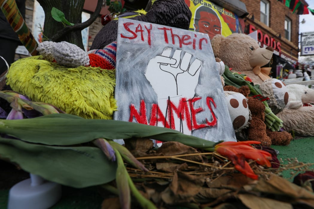 People lay flowers at a memorial in George Floyd Square in Minneapolis, Minnesota, United States on April 21, 2021.