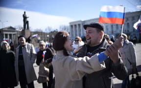 A man holds a Crimean flag outside the Crimean parliament building in central Simferopol.
