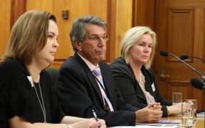 Chief Ombudsman Judge Peter Boshier (center), Deputy Ombudsman Compliance  and Practice Emma Leach (left) and Chief Inspector OPCAT Jacki Jones, (right) speak to the Law and Order Committee about the illegal restraint of at-risk prisoners.