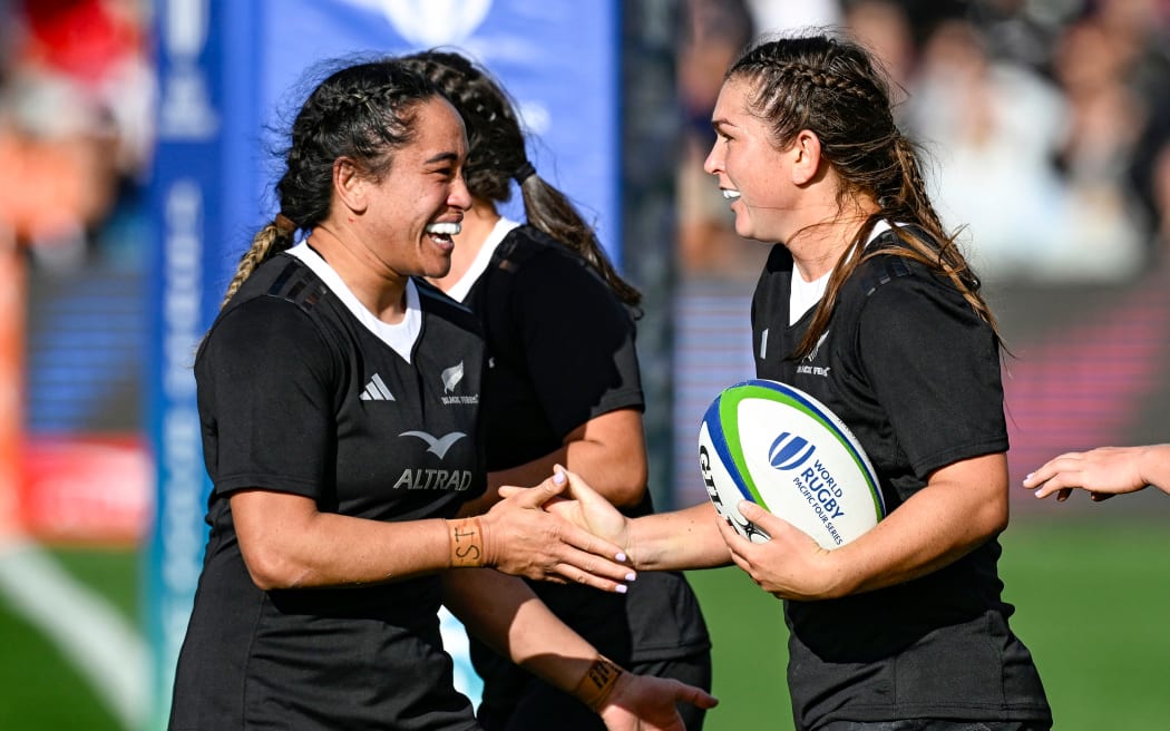 Georgia Ponsonby (R) of New Zealand celebrates her try.