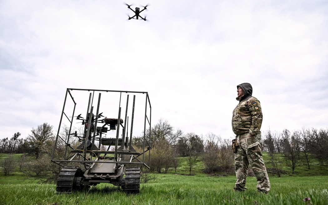 A soldier with the call sign ''Pavuk'' (''Spider'') watches a drone take off from a ground robotic complex during trials at a training ground.