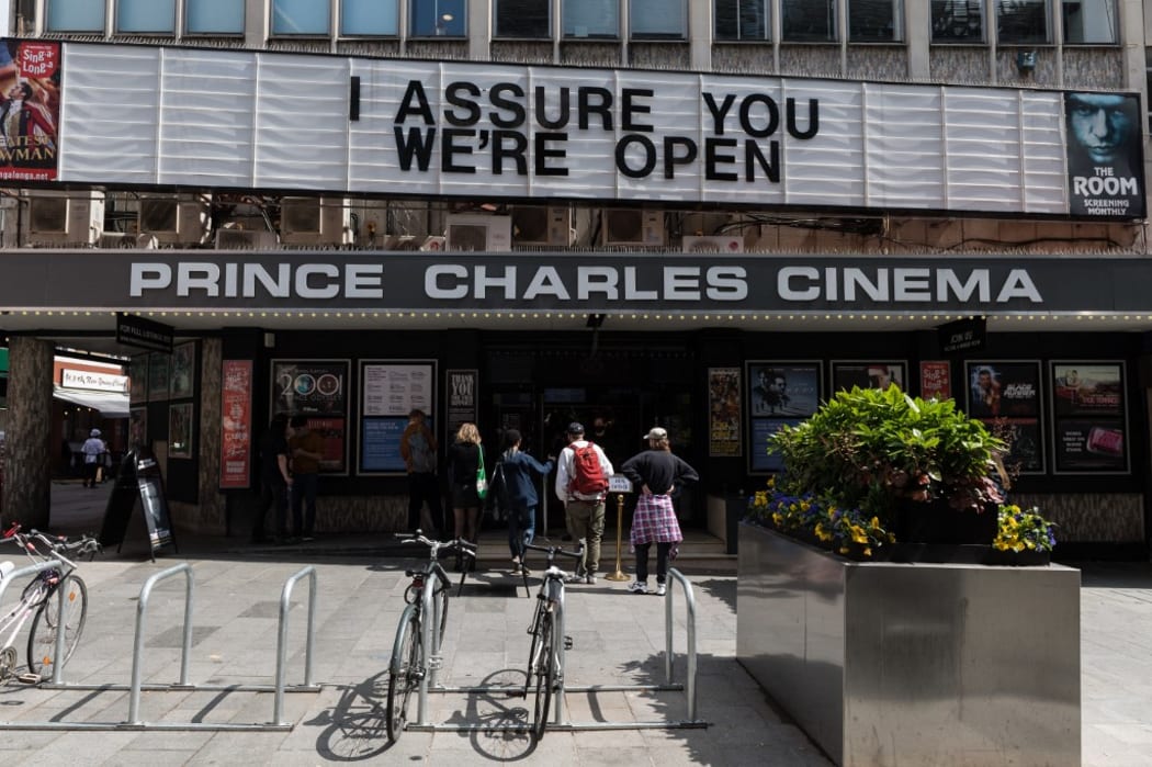 LONDON, UNITED KINGDOM - MAY 17, 2021: People queue outside Prince Charles Cinema as England moves to Step 3 in easing of coronavirus restrictions, on 17 May, 2021 in London, England.