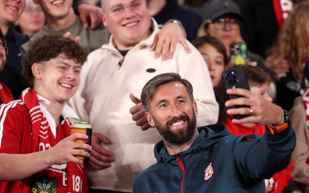 Wrexham AFC's Ollie Palmer poses for a selfie with fans, Melbourne, 2025.