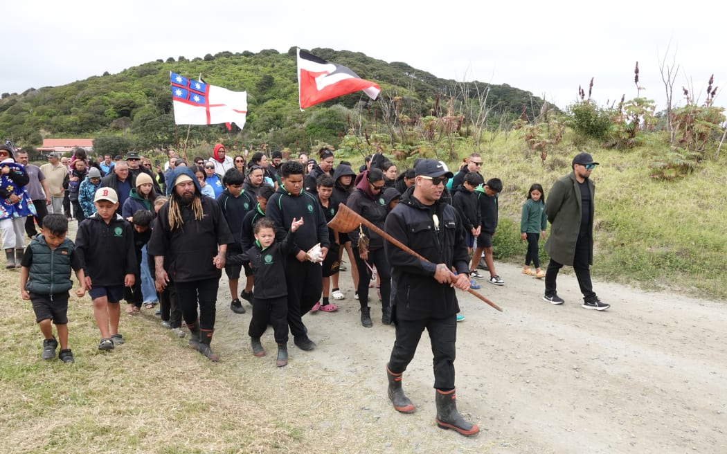 Pene Tawhara leads a hīkoi at Whatuwhiwhi, on the Karikari Peninsula, sparked by what hapū members say is desecration of wāhi tapu.