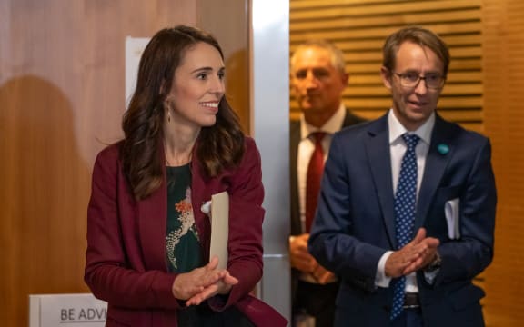 Prime Minister Jacinda Ardern sanitises her hands with Director-General of Health Dr Ashley Bloomfield while walking to a Covid-19 coronavirus briefing on 6 May, 2020.