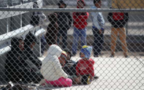 Detained migrants wait to be transported by the US Border Patrol at the border of the United States and Mexico.