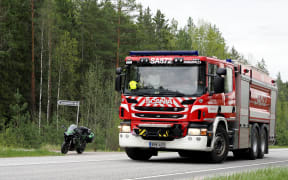 A fire department vehicle arrives at the crash site near the Eura Airfield in Eura, Finland, on May 17, 2025 where two civilian helicopters crashed in Eura according to the Satakunta rescue department. Several people died on May 17, 2025 when two helicopters carrying a total of five collided mid-air in Finland and crashed to the ground, police said.
"The accident has resulted in several fatalities. The exact number of victims and the identities of the passengers are still being determined," the police said in a statement. (Photo by Petri Hakosalo / various sources / AFP) / Finland OUT / FINLAND OUT / FINLAND OUT
