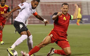 PNG captain Alwin Komolong tackles Fiji skipper Roy Krishna.